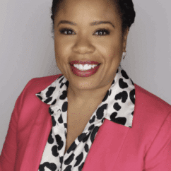 Kristen Dufauchard smiling at the camera against a gray background.